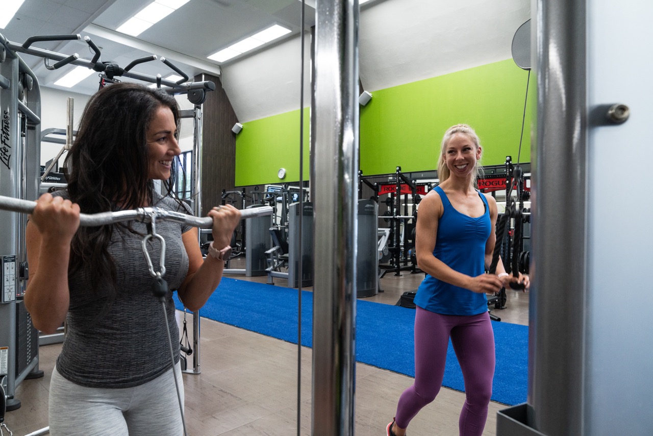 Head trainer, Amber doing a bicep curl on the cable machine at downtown Calgary's Fifth Avenue Club